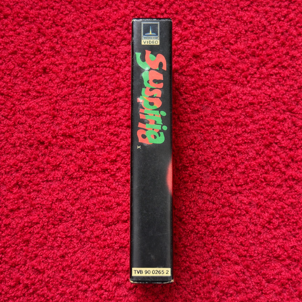 Black video tape with colorful text on a red textured background