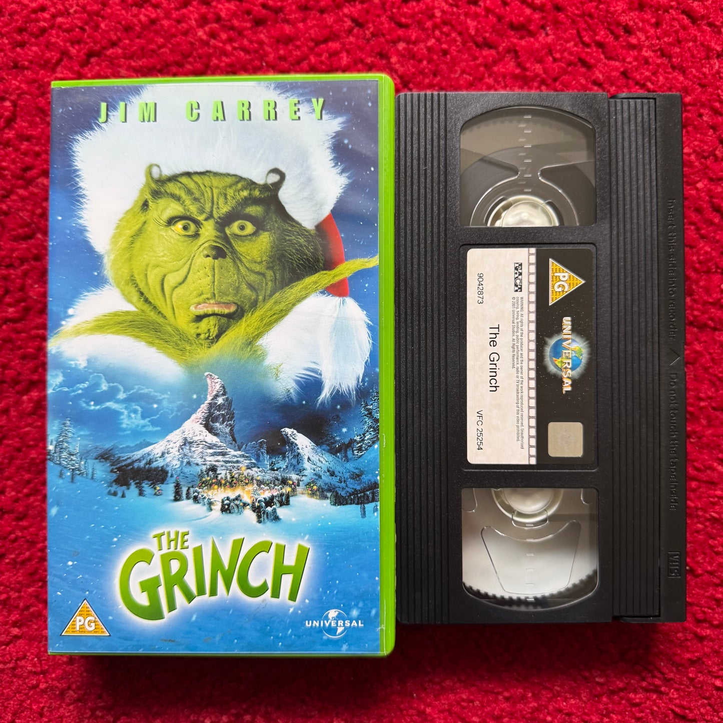 VHS tape of 'The Grinch' with cover on a red background