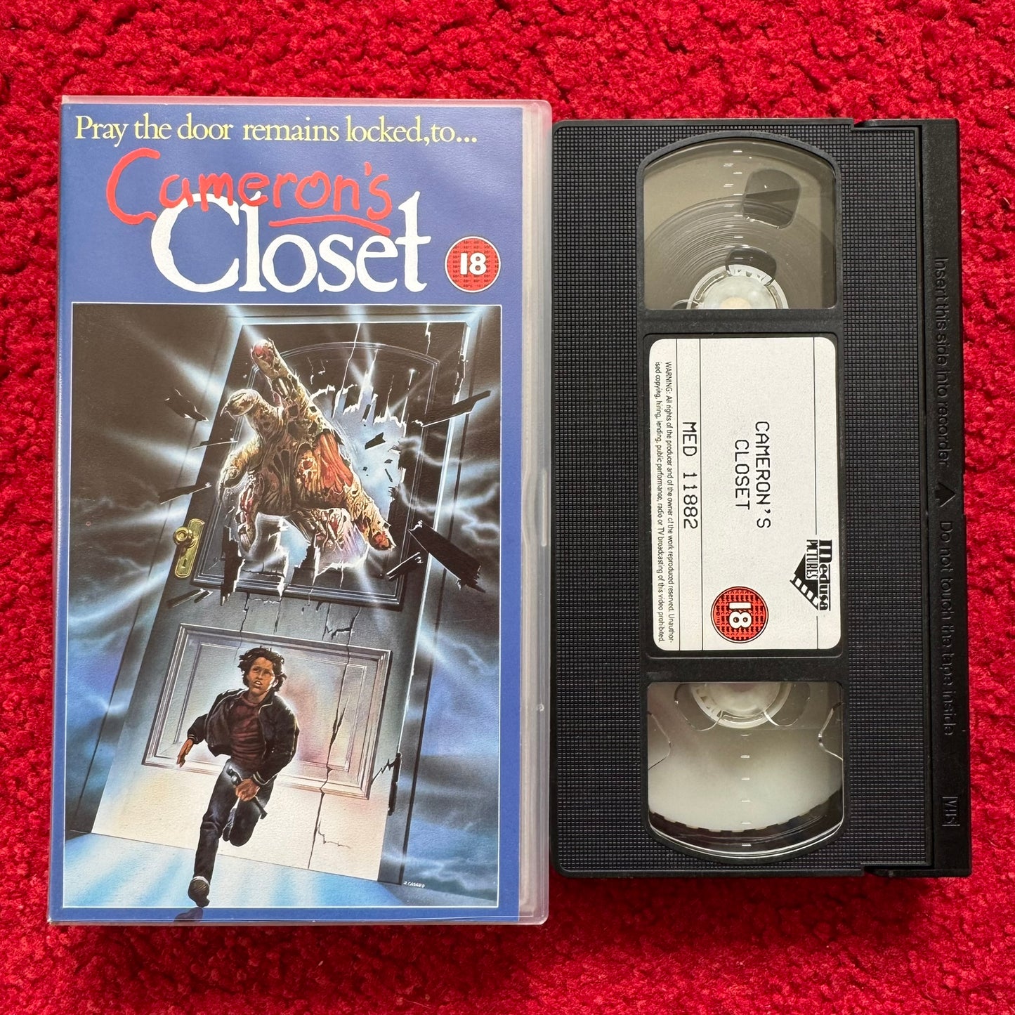 Cameron's Closet VHS horror film with cover art featuring a terrifying creature and a fleeing character