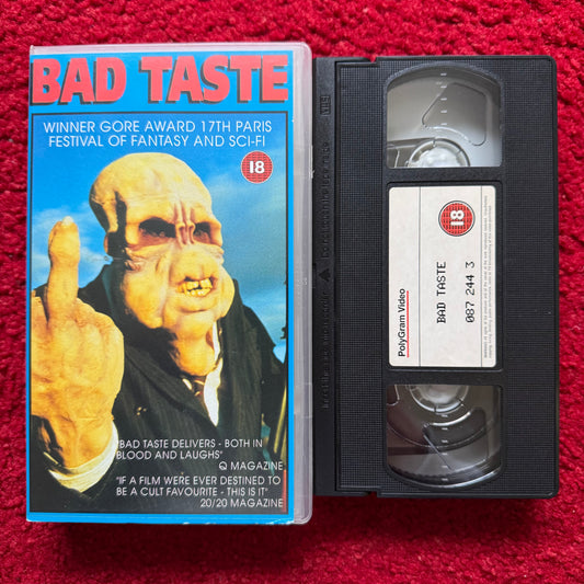 VHS tape of 'Bad Taste' with cover on a red background