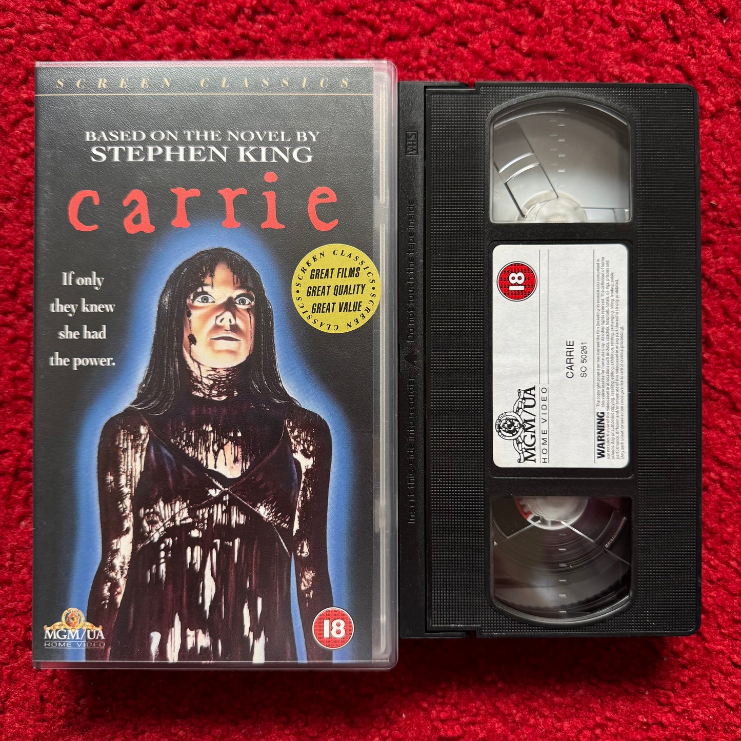 VHS tape of 'Carrie' by Stephen King on a red background