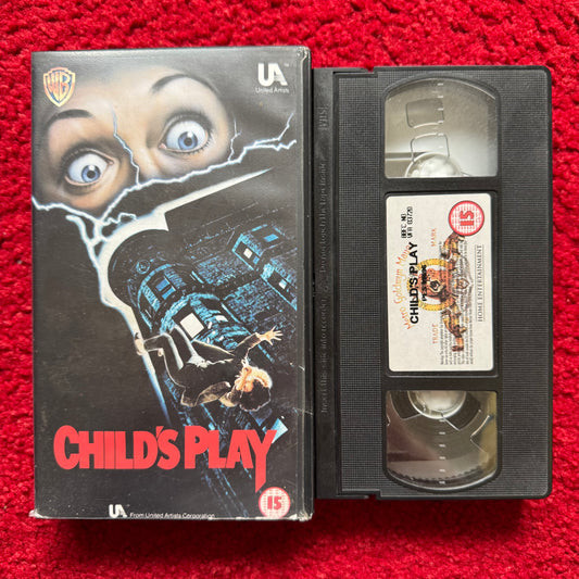 VHS tape of 'Child's Play' with cover on a red background