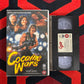 VHS tape of 'Cocaine Wars VHS' with movie poster on a red and black striped background