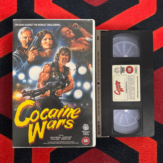 VHS tape of 'Cocaine Wars VHS' with movie poster on a red and black striped background