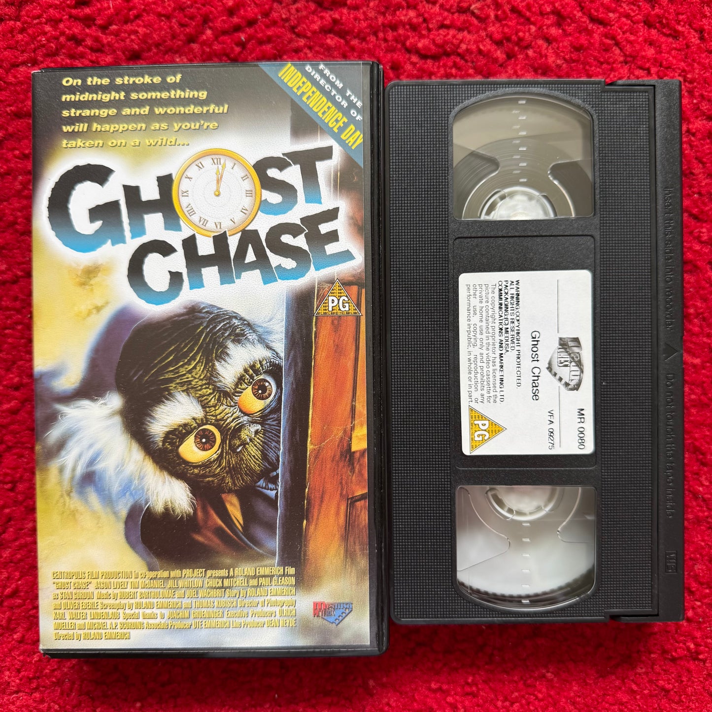 VHS tape of 'Ghost Chase' with cover on a red background