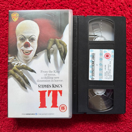 VHS tape of 'IT' by Stephen King with cover on a red background