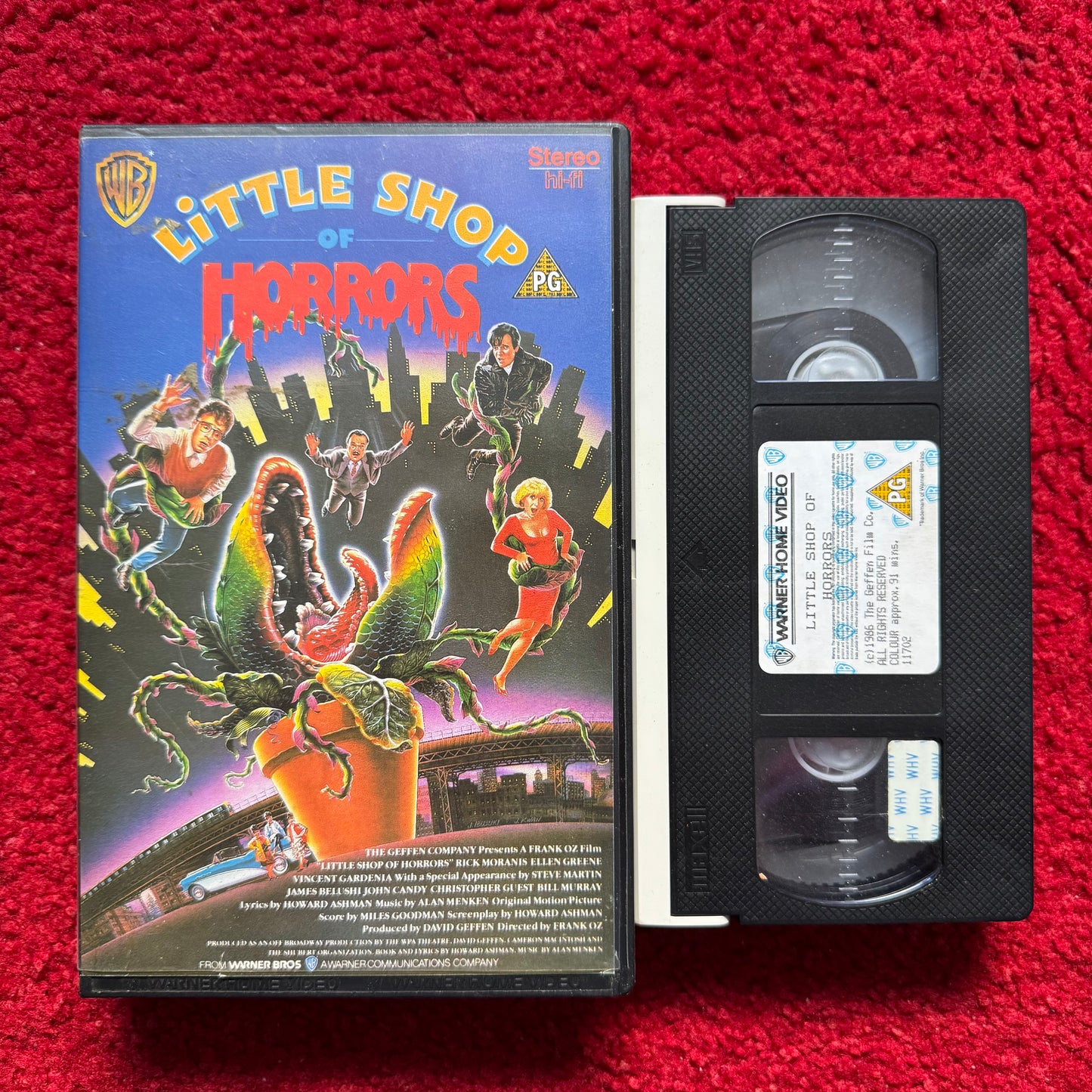 VHS tape of 'Little Shop of Horrors' with cover on a red background