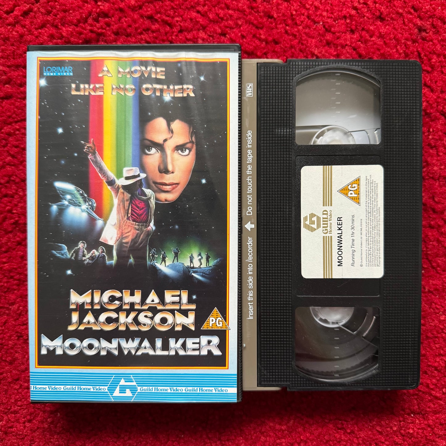VHS tape of 'Michael Jackson's Moonwalker' with cover on a red background