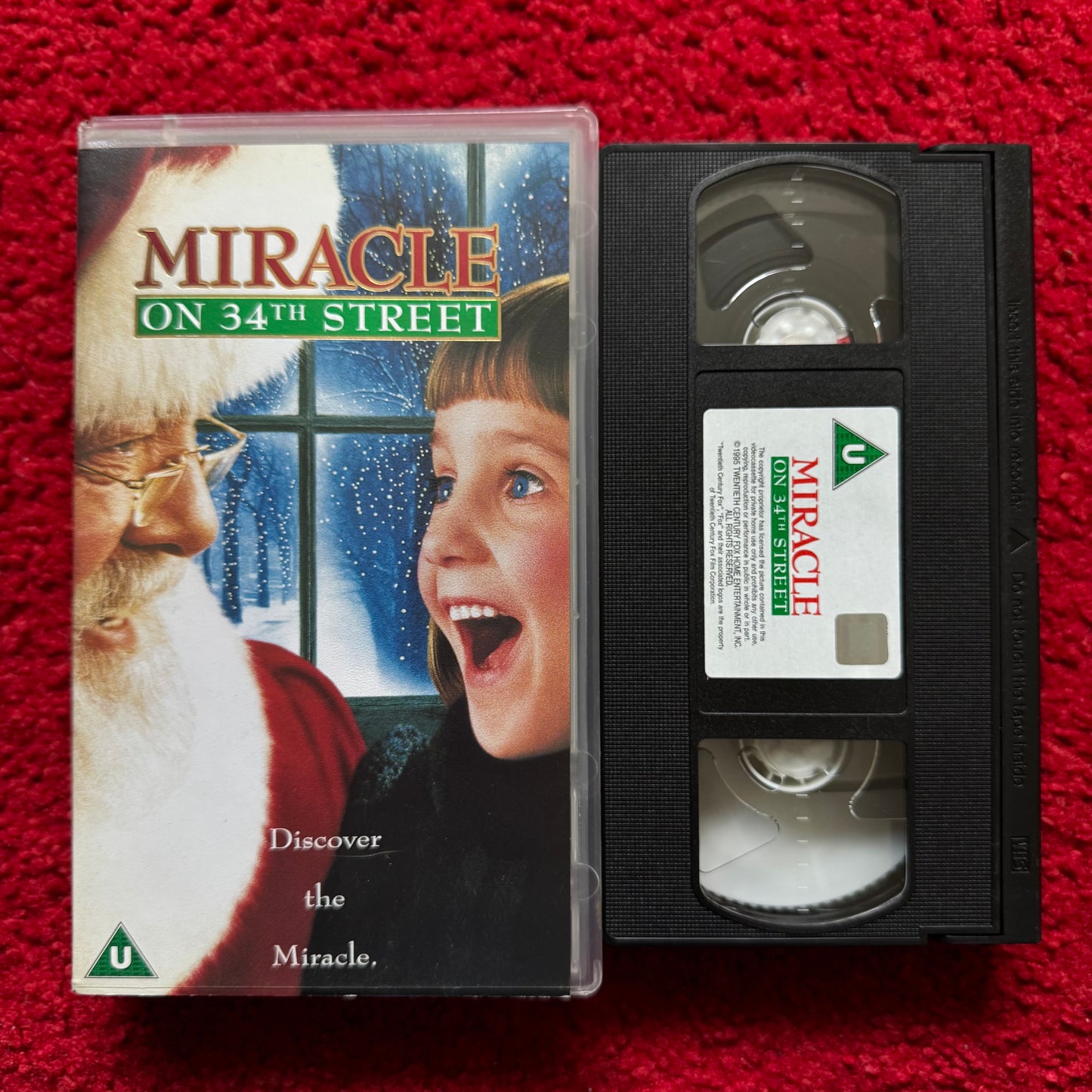 VHS tape of 'Miracle on 34th Street' with cover on a red background