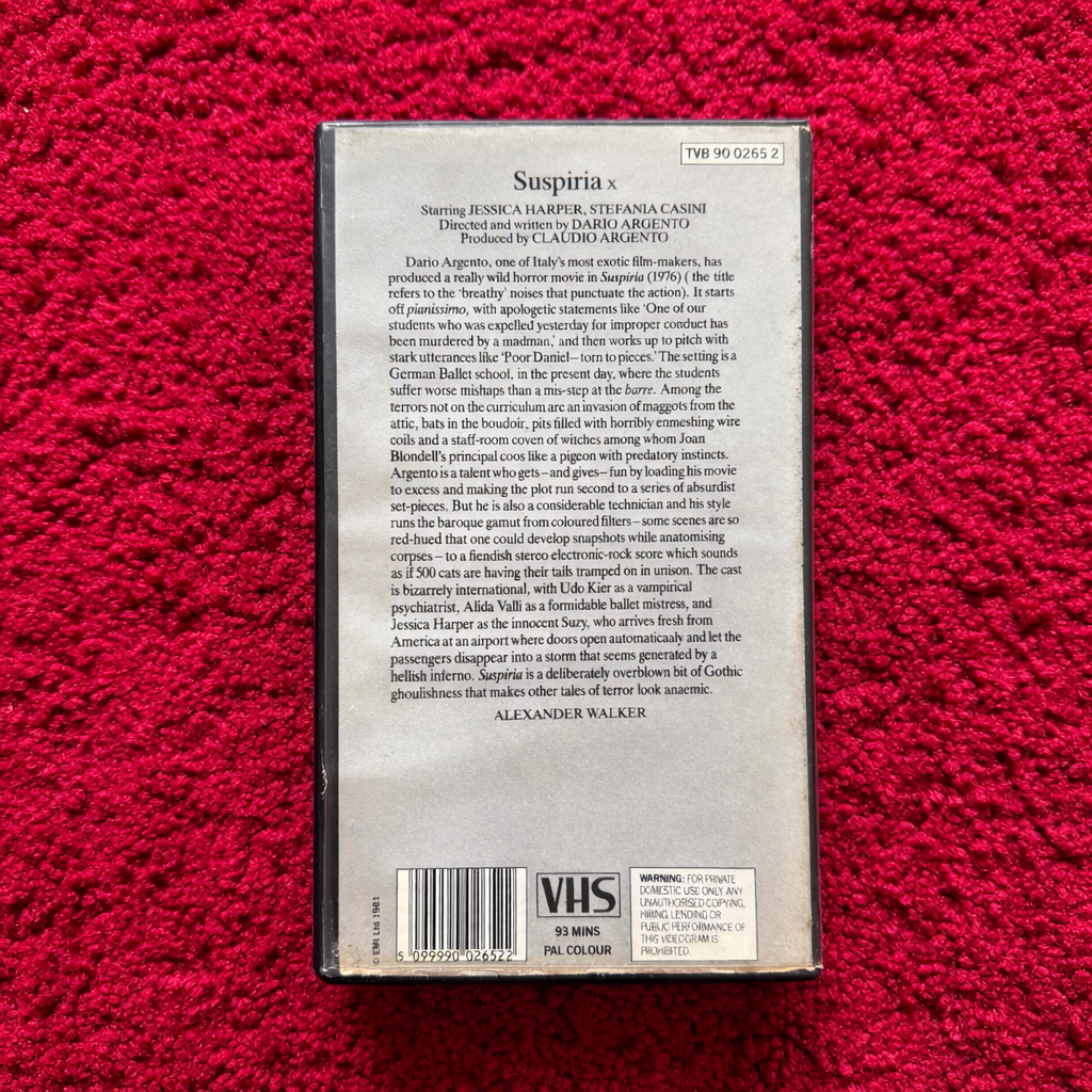 VHS tape cover of 'Suspiria' on a red textured background