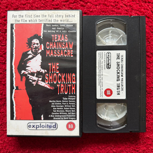 VHS tape of 'Texas Chainsaw Massacre: The Shocking Truth' with cover on a red background