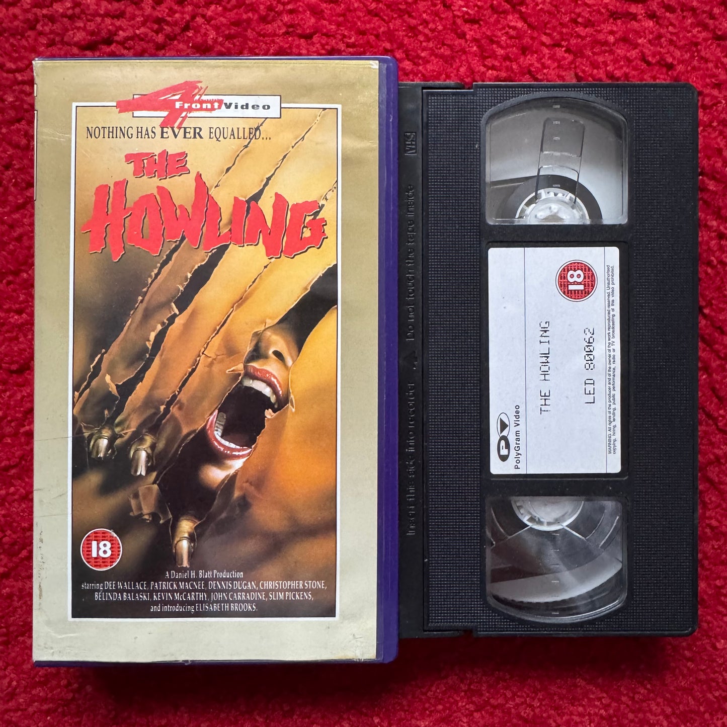 VHS tape of 'The Howling' with cover on a red background
