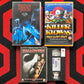 A collection of classic horror movie VHS tapes and a rental copy shown on a red and black patterned background. The tapes include Freddy vs Jason, Killer Klowns from Outer Space, and Halloween Resurrection, with one VHS tape open to show the tape and case.